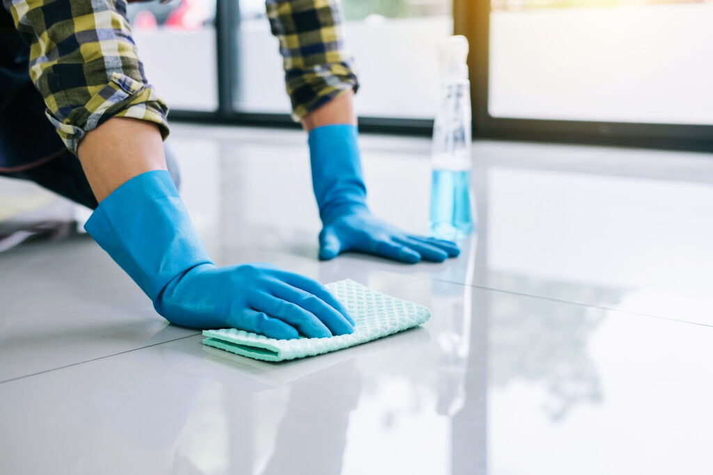 Person cleaning floor with a sponge.